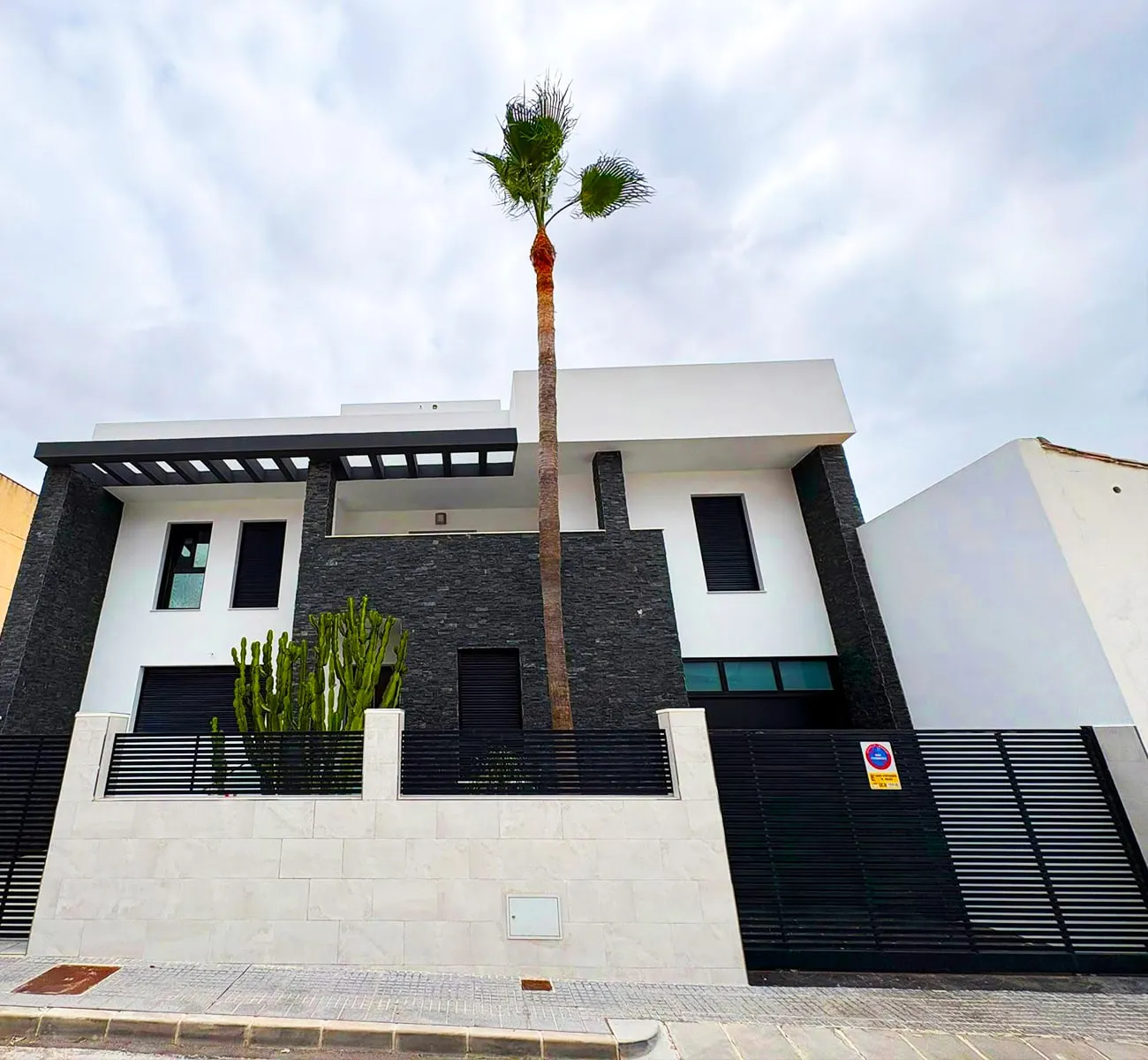 Villa moderna: paramentos pintados en blanco junto a la piedra oscura